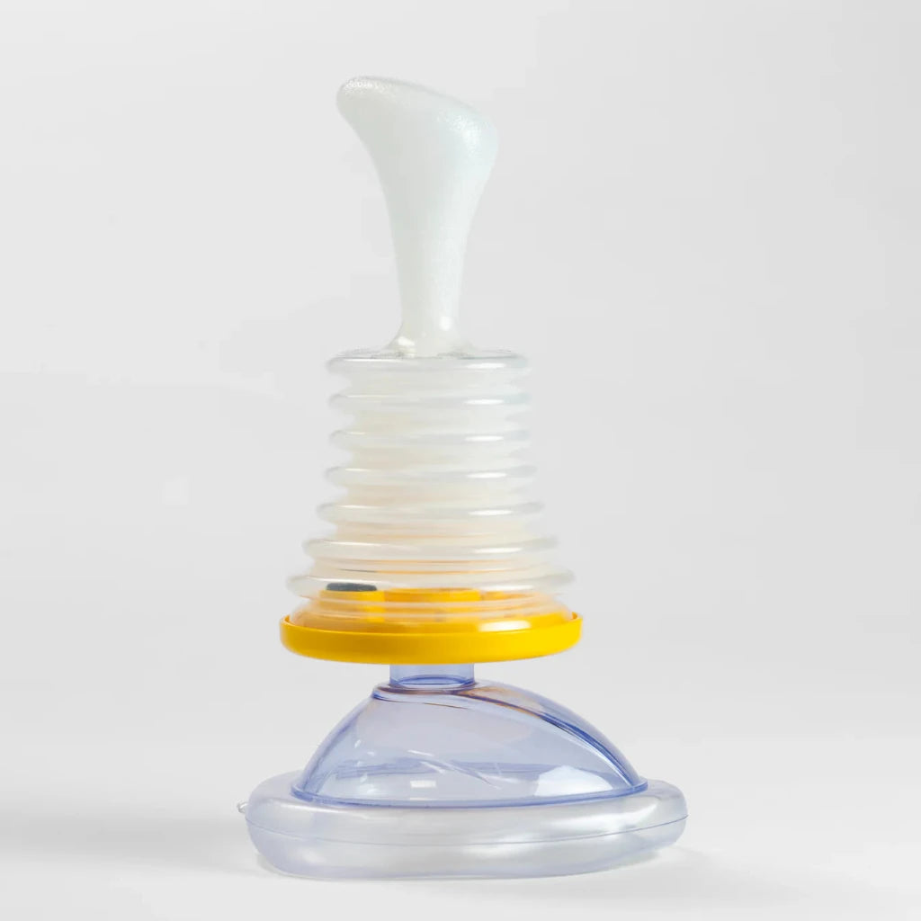 Clear and yellow baby bottle with white cap on a white background