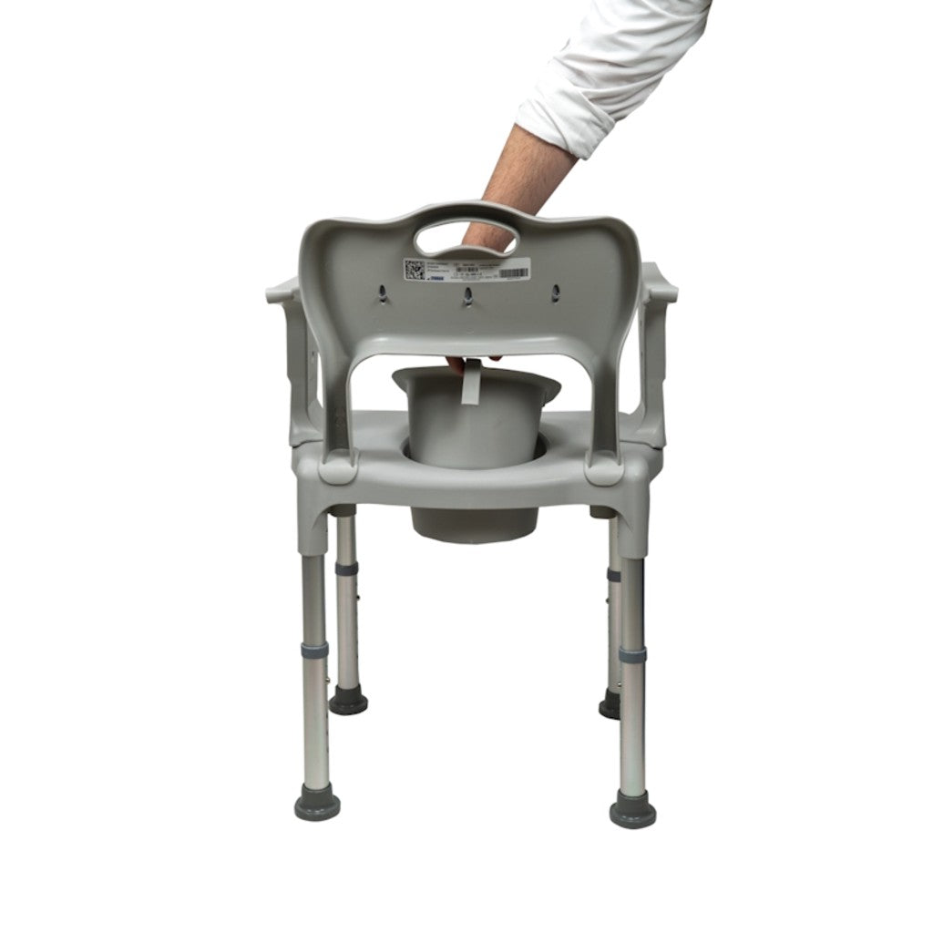 Removing the bucket from the back of the commode chair
