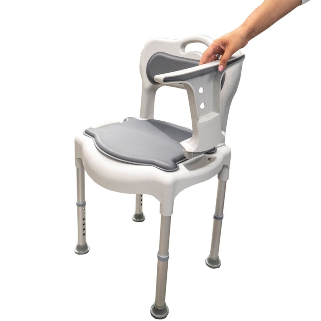 Detachable armrest of the height adjustable commode chair being lifted off